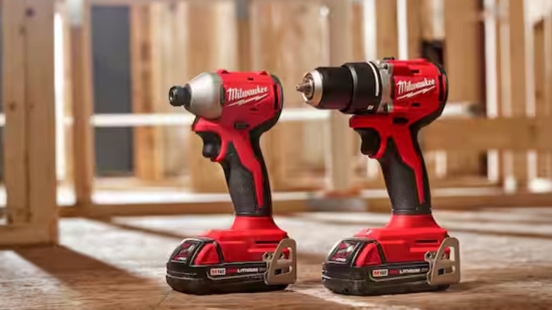 Milwaukee brushless cordless compact drill impact combo kit on display at a worksite.