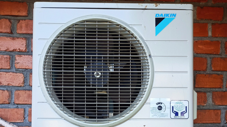 outdoor unit for a Daikin ductless mini split air conditoner mounted on a brick wall