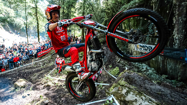 GasGasn trials bike image with one wheel in the air during off-roading