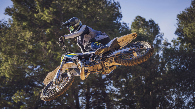 Husqvarna motocross bike photographed while jumping
