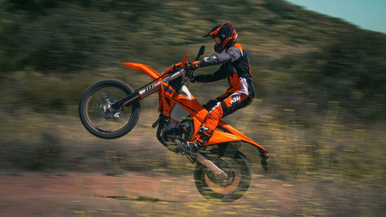 KTM 350 dual sport side profile with the front wheel in the air dynamic image