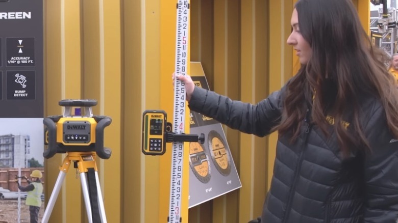 Person demonstrating DeWalt 20V Max XR Green Rotary Laser at World of Concrete 2026