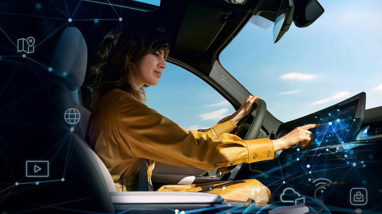 A person using a screen on the car dashboard