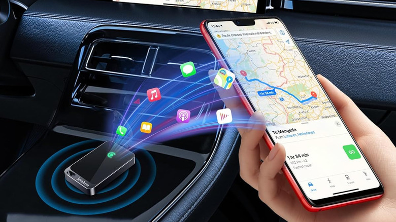 A person using Apple CarPlay on their phone inside a vehicle