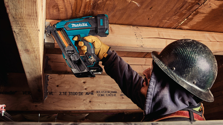 A carpenter using the new XNB09 positive-placement metal connector nailer.