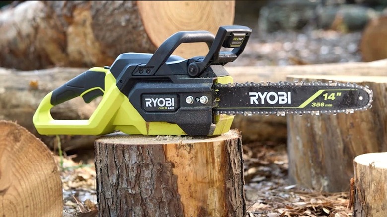 Ryobi 18V chainsaw pictured on top of a cut log