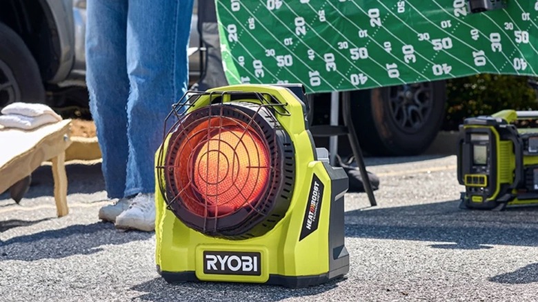 Person using Ryobi 18V propane heater at a tailgate party