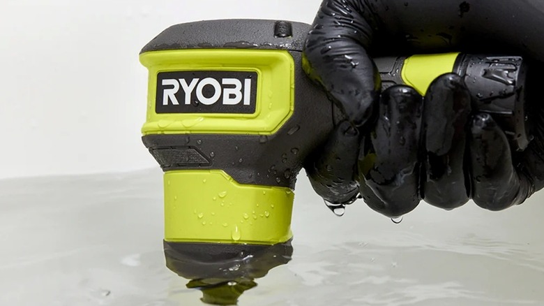 The Ryobi USB Lithium drain auger being used to clean out a clogged drain.