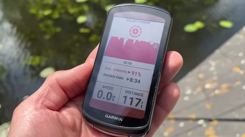 Garmin Edge 1040 Solar held in one hand.