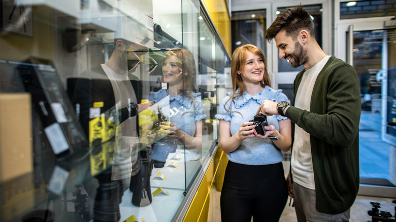 A couple shopping for a camera in a store