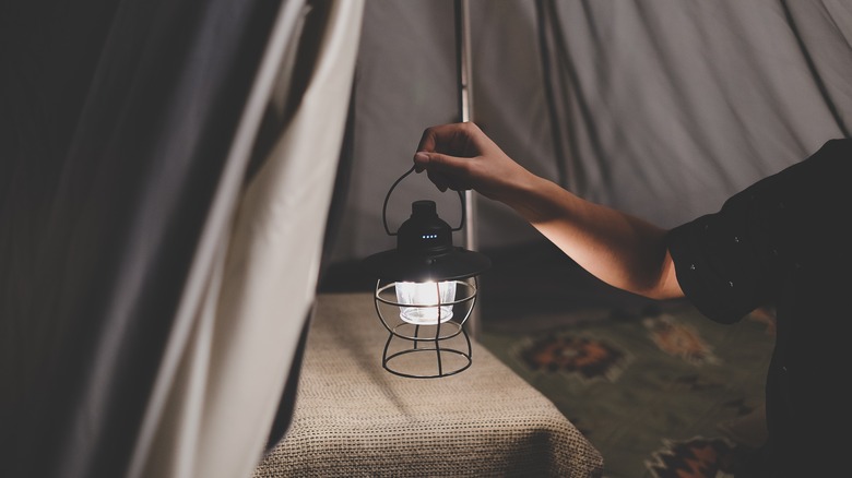 hand holding camping lantern