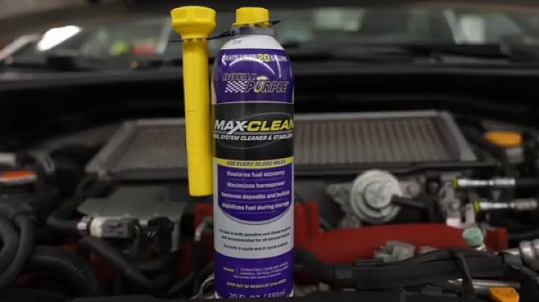Bottle of Royal Purple fuel system cleaner on the hood of an engine