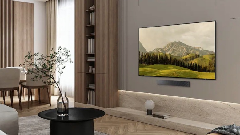 A setup of a room with the Samsung OLED TV mounted on the wall