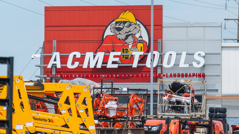 An Acme Tool storefront behind some work vehicles.