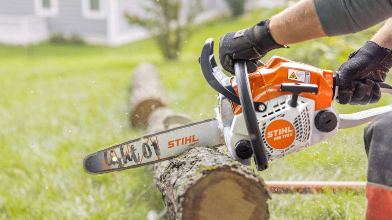 The Stihl MS 172c chainsaw used to cut up a log.