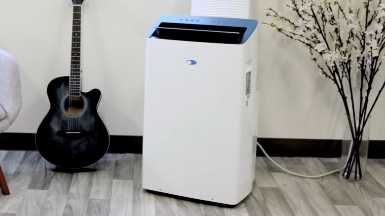 A Whynter portable air conditioner set up in a room.