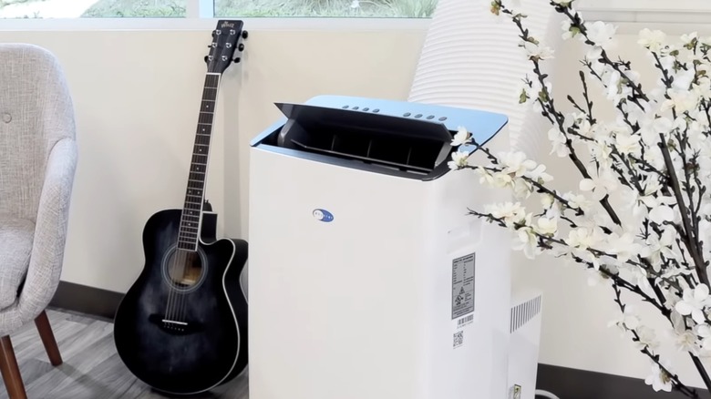 A Whynter air conditioner set up in a living room.