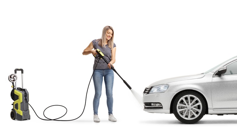 A person power spraying a car