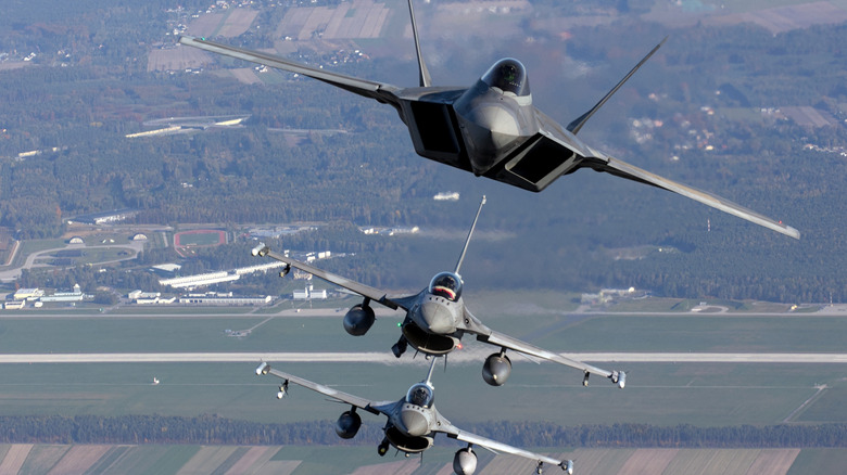 F-22 Raptor and F-16 Fighting Falcons flying in formation