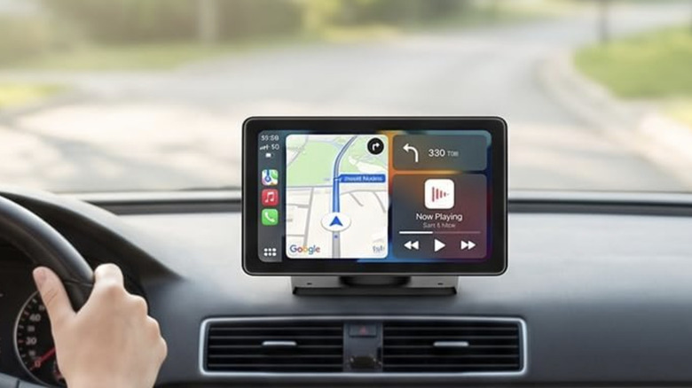 A driver using Google Maps on a dashboard-mounted CarPlay screen