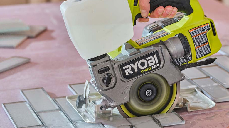 person using ryobi cordless saw
