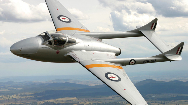 De Havilland Vampire flying over mountainous terrain