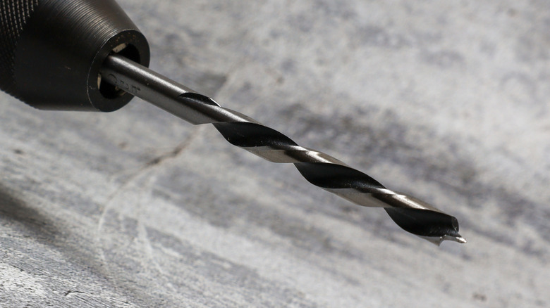 A drill bit against a gray background.