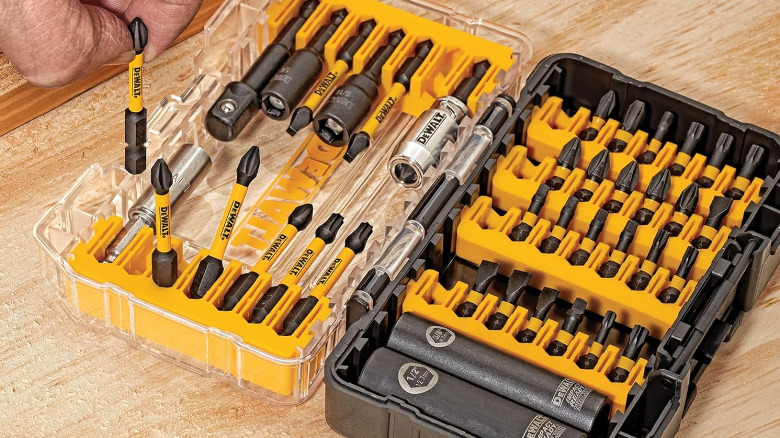 A person picking a driver bit from a boxed DeWalt impact-rated bit set.