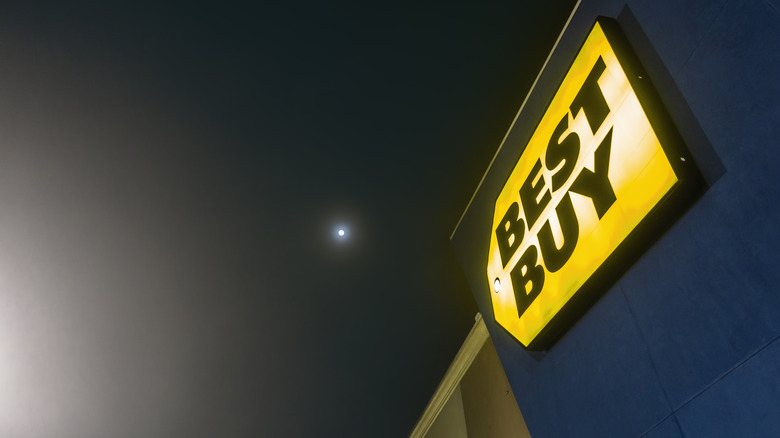 Picture of a Best Buy store sign at night.