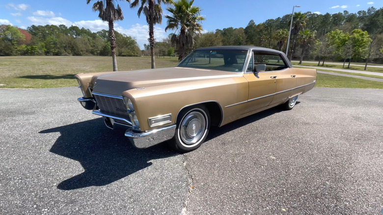 1968 Cadillac Sedan Deville on tarmac, front 3/4 view, palm trees in the background