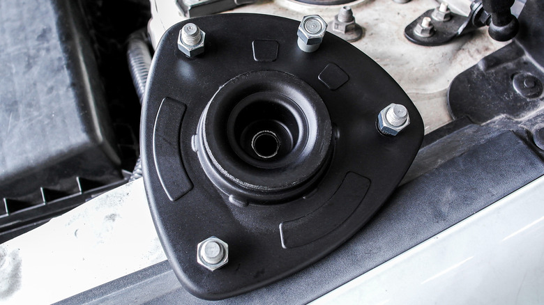 A strut mount resting inside a car.