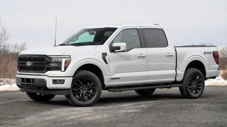 A white Ford F-150 parked on a gravel outside in the winter