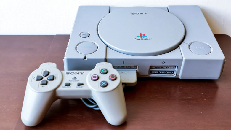An original PlayStation gaming console with a controller
