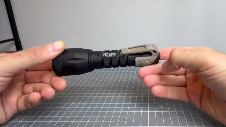 Person holding an Elzetta Bravo flashlight.
