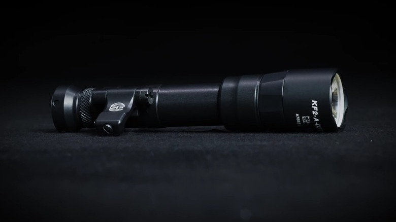 A SureFire Turbo Series flashlight on a surface.