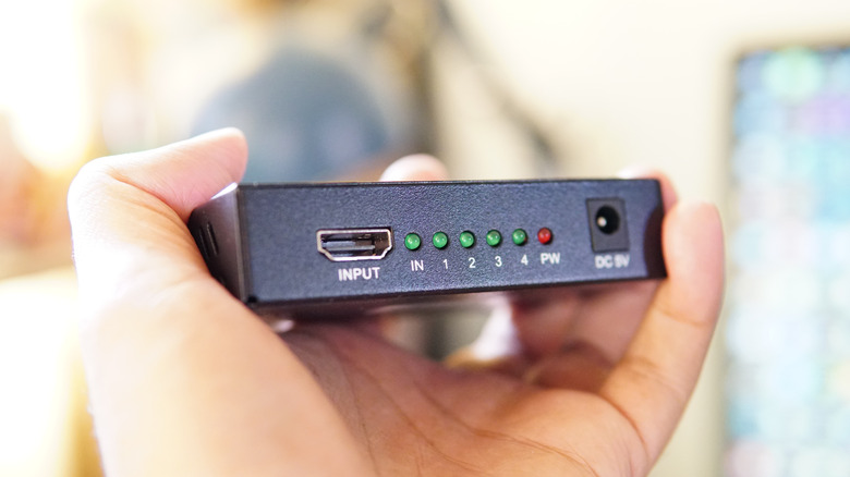 HDMI splitter in person's hand