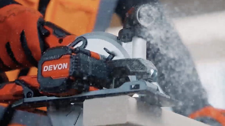 worker using a Devon circular saw to saw a piece of wood