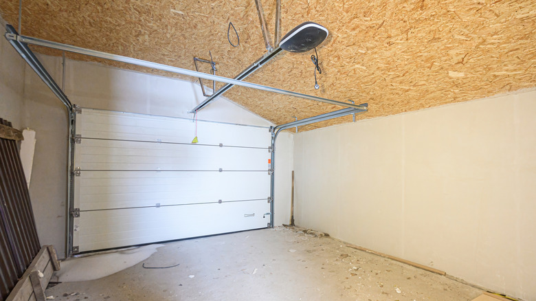 An unfinished garage space with a door installed