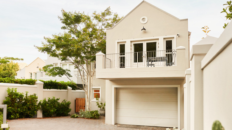 Front view of a white, contemporary home with a garage