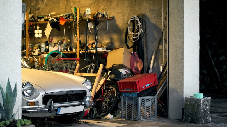 Car parked in a cluttered garage
