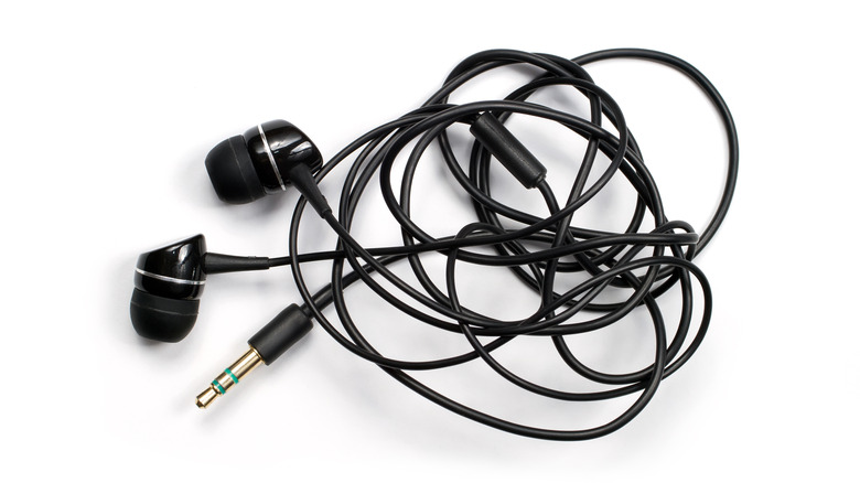 Wired earbuds against a white background.