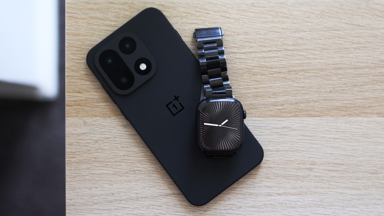 An Apple Watch resting on a OnePlus phone
