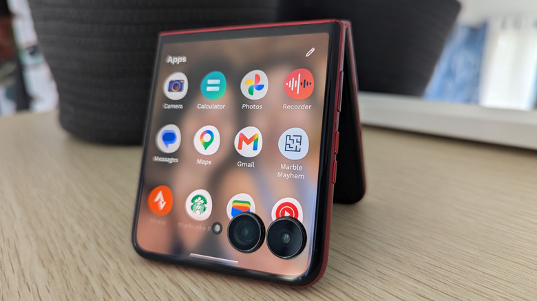 Motorola Razr Ultra 2025 propped up tent-style on a table showing app icons on screen