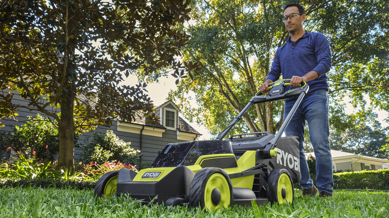 Man uses a Ryobi lawn mower