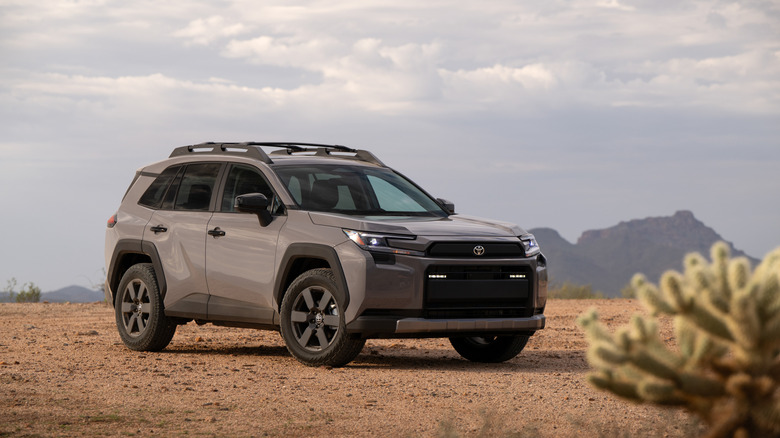 A 2026 Toyota RAV4 Woodland in gray in the desert, front 3/4 view