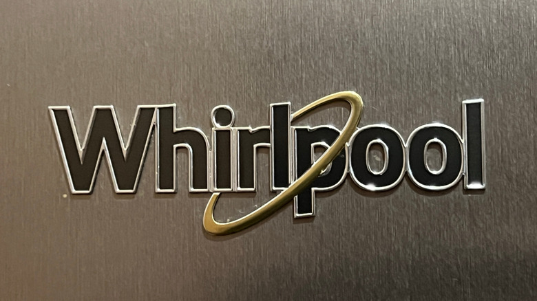 Close-up of the Whirlpool logo on a shiny stainless steel surface