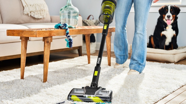 person using ryobi vacuum