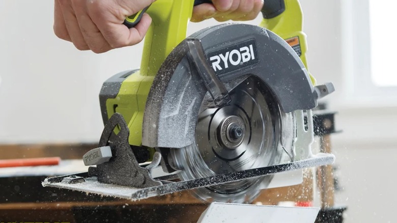 A person using a Ryobi circular saw.