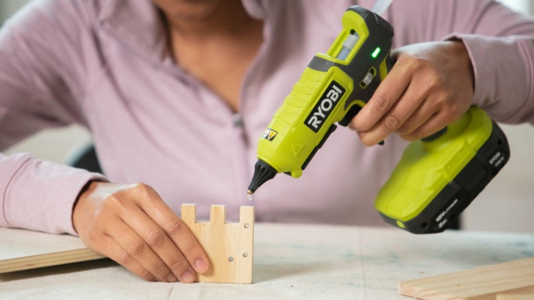 A person using Ryobi glue gun