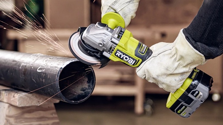 Person cutting pipe with Ryobi One+ 18V HP Brushless 4 ½-inch Angle Grinder